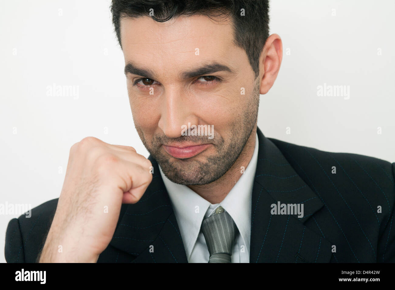 Midadult businessman clenching fist, smiling Stock Photo Alamy