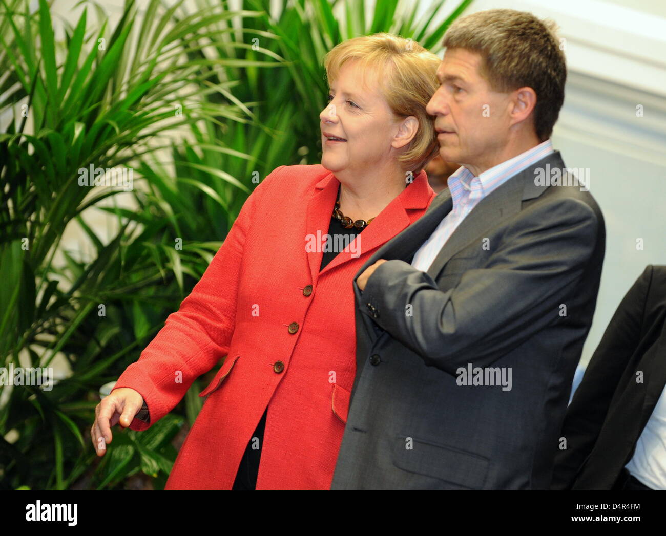 German Chancellor Angela Merkel (R) and her husband Joachim Sauer (L ...