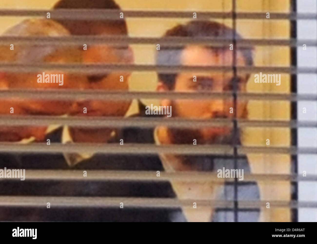 A bearded man (R) is handcuffed in a room of the Federal Court of Justice (BGH) in Karlsruhe, Germany, 02 October 2009. The Office of the Federal Prosecutor had an alleged supporter of terror network al-Qaeda arrested on 01 October. Adnan V., 24-year-old of German and Turkish nationality, appeared before the BGH?s investigating judge on 02 October. Photo: ULI DECK Stock Photo