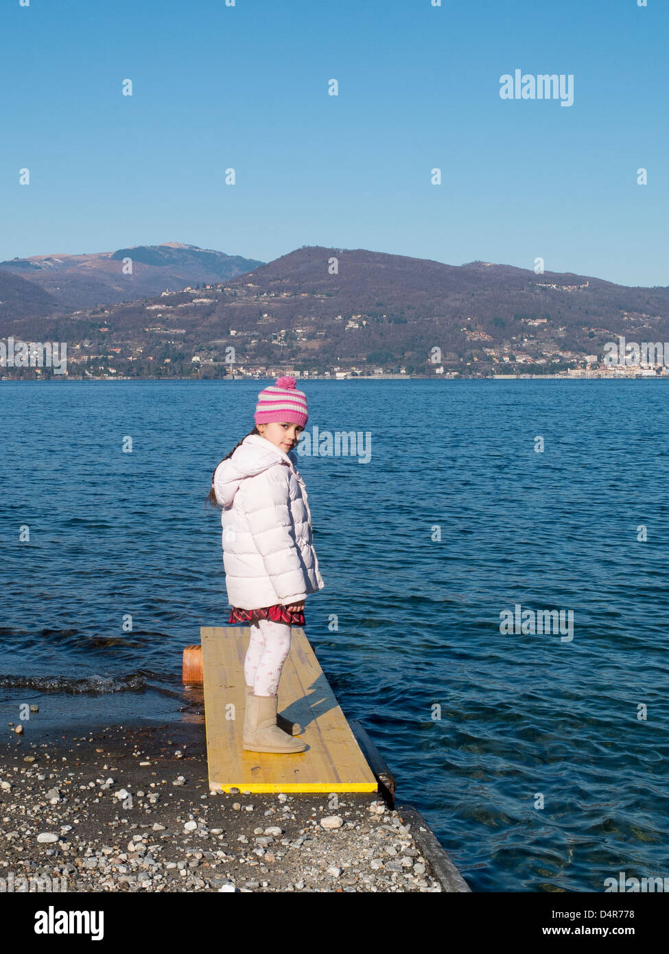 little girl by the lake on a winter day Stock Photo - Alamy