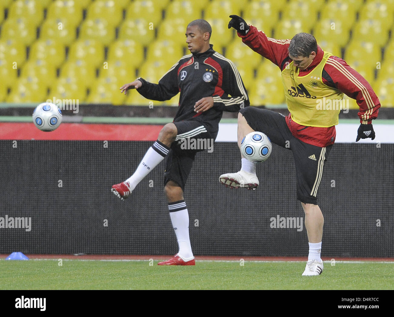 Germany internationals Jerome Boateng (L) and Bastian Schweinsteiger (R) control the ball as the German national team trains on artificial turf in Moscow, Russia, 09 October 2009. The German team faces Russia?s squad for a crucial FIFA 2010 World Cup qualifier on 10 October to be held on artificial turf at Luzhniki stadium of Moscow. Photo: ACHIM SCHEIDEMANN Stock Photo