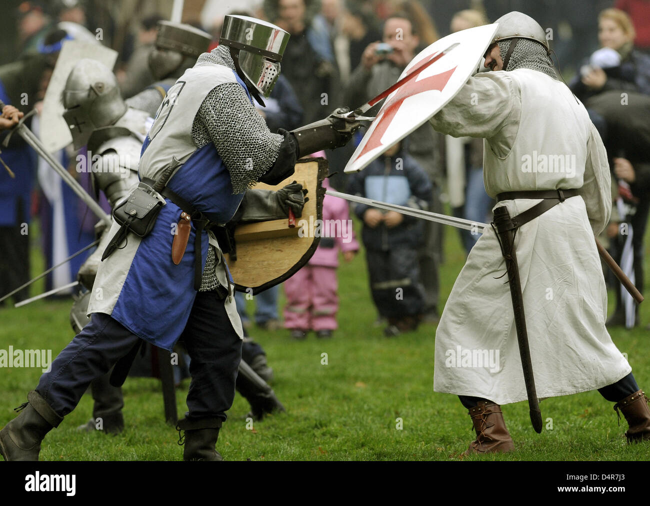 Knights with swords fight during a show fight at the medieval games in