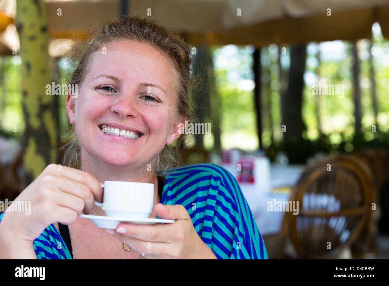 Nothing makes me happier than a cup of Turkish coffee in the mornings. A large smile comes from a Turkish girl. Stock Photo