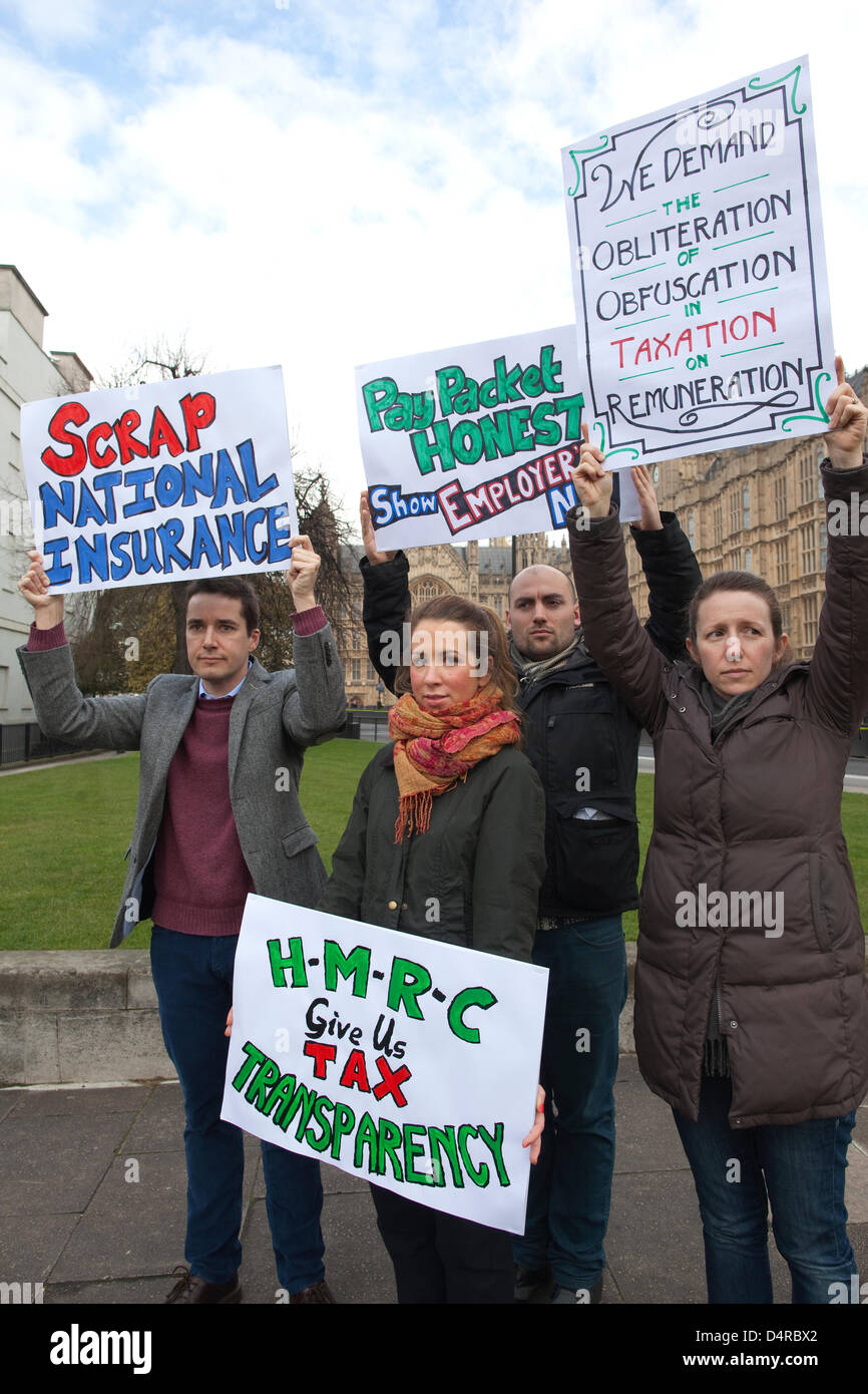 College Green, Westminster, London, UK. 18th March 2013.  The TaxPayers' Alliance and supporters hold a tax reform protest to coincide with the release of a YouGov survey on the public's understanding of and attitudes to public spending and taxation. Here (clockwise from bottom centre) Eleanar McGrath holds a placard requesting the HMRC to give tax transparency, J P Floru, Chris Lowe and Sara Rainwater on College Green. Credit: Jeff Gilbert / Alamy Live News Stock Photo