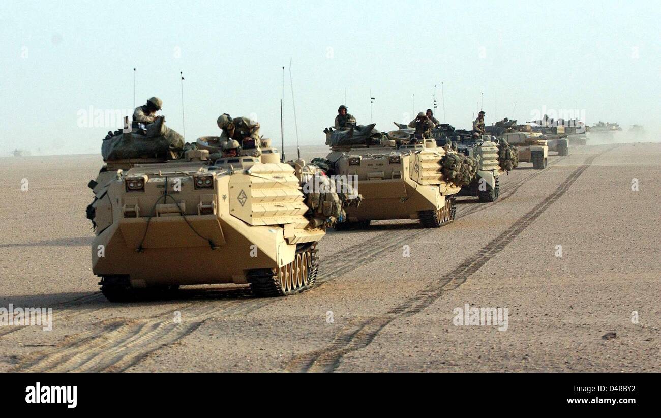 Convoys with amphibious vehicles and battle tanks type M1-A1 Abrahams of the 1st Tank Battalion of the 1st US Marines Division advance from their Camp Coyote in Kuwait to the Iraq border on 19 March 2003. The soldiers are waiting for Bush's order after the expiration of the 48-hour-ultimatum. Stock Photo