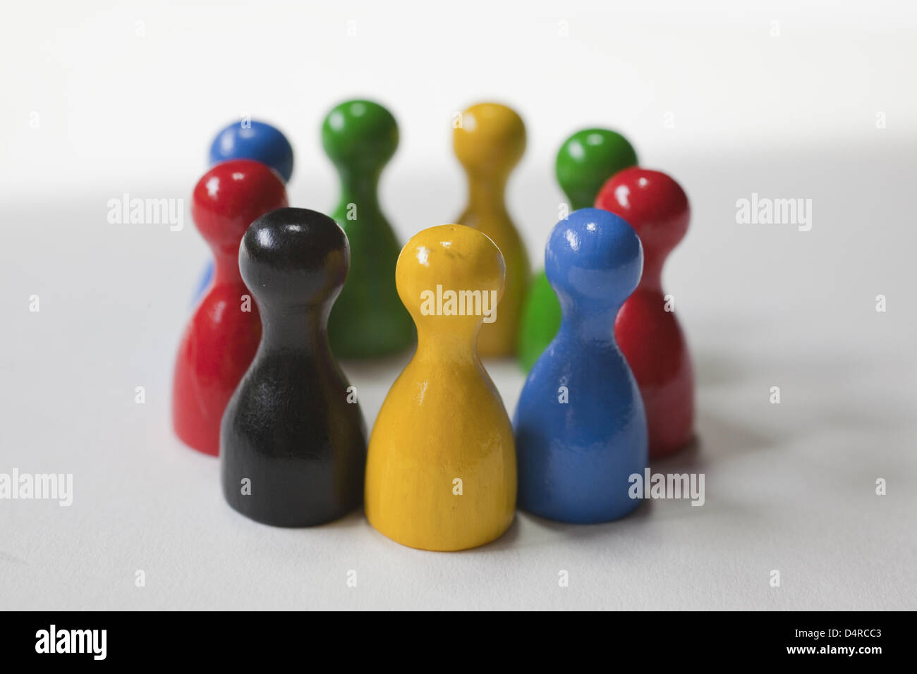 ILLUSTRATION Several board game figures in various colours form a