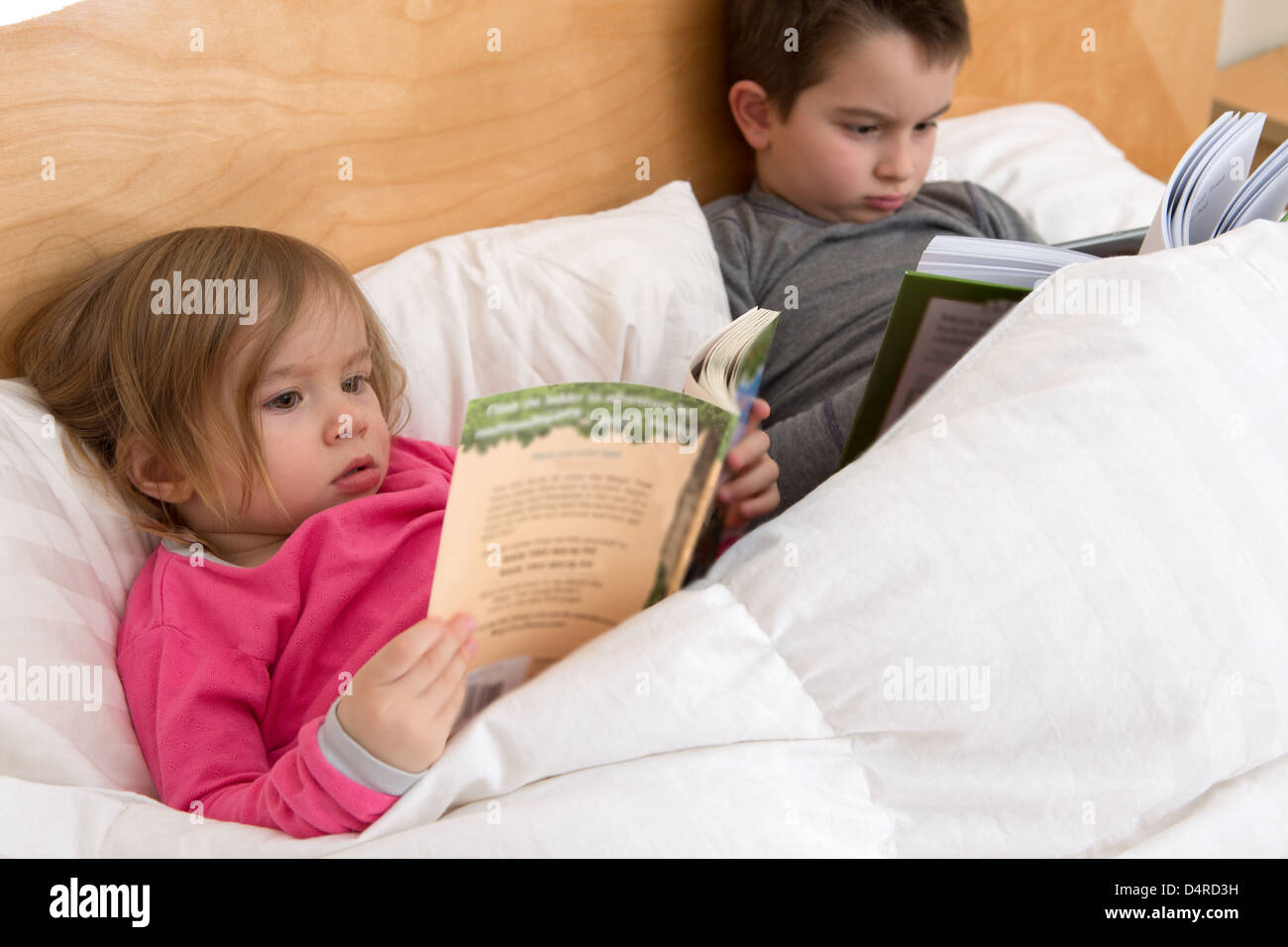 Reading habits starts with early age; siblings are reading their books before fall asleep