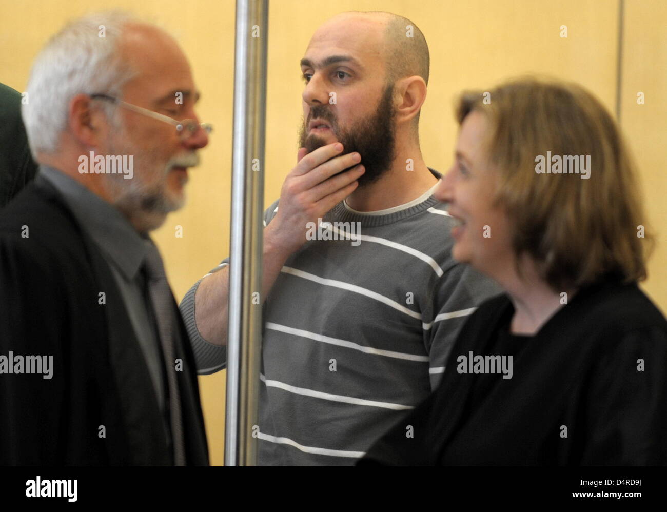 Defendant Adem Yilmaz stands in the hearing room at the Higher Regional Court in Duesseldorf, Germany, 10 August 2009. His lawyer Karl Engel is pictured on the left. The defendants in the terror trial against the so-called ?Sauerland group? kept their word and started making broad confessions. The four men already had more than 1000 pages of confessions recorded in custody in the l Stock Photo