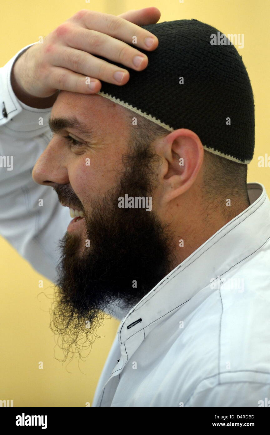 Defendant Adem Yilmaz smiles in the dock as his trial continues at the higher regional court in Duesseldorf, Germany, 11 August 2009. In the so-called Sauerland trial against the Islamist terror group, alleged ringleader Gelowicz is expected to continue confessing broadly. The previous day, Gelowicz had confessed having planned terrorist attacks on US soldiers in Germany for the Is Stock Photo
