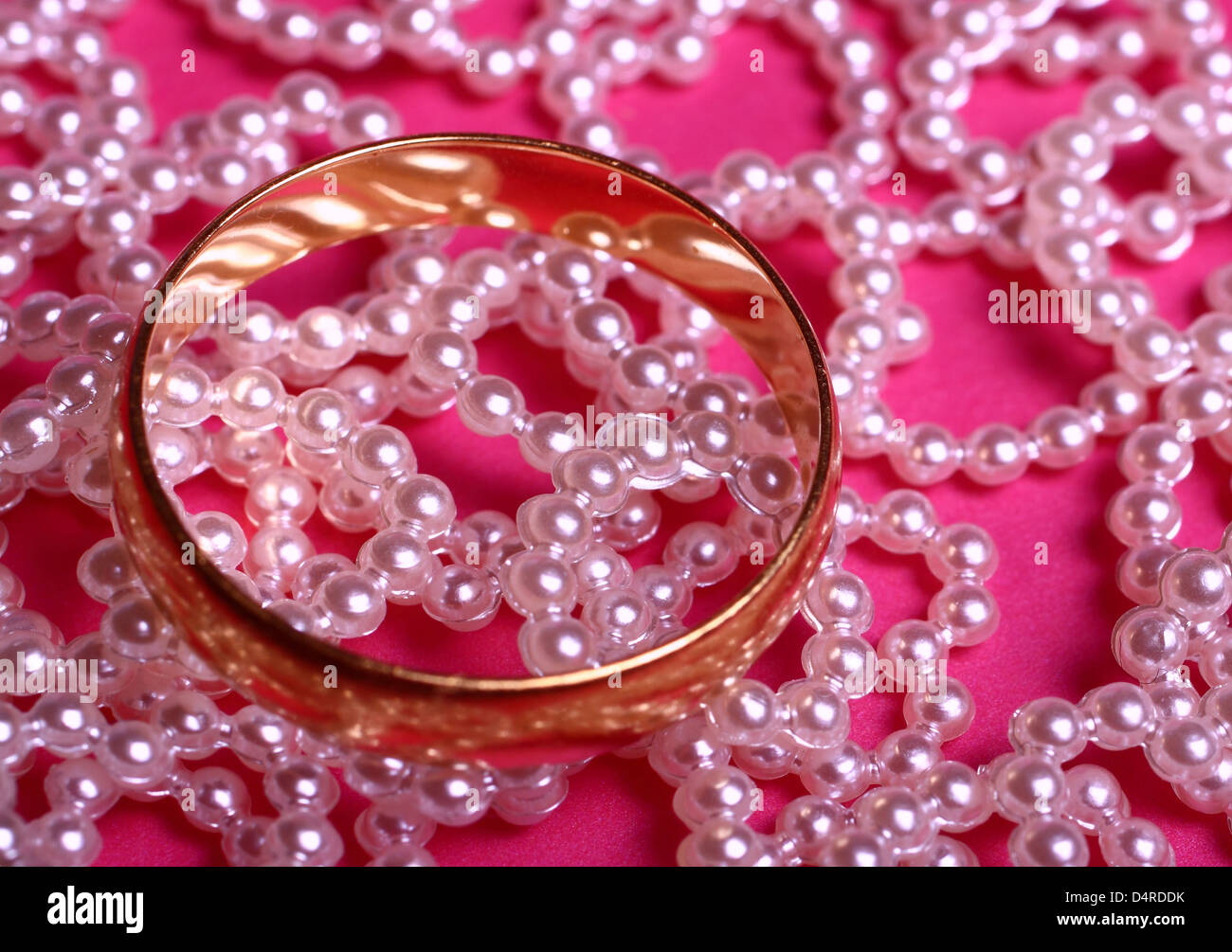 Wedding ring on heart embellishments Stock Photo