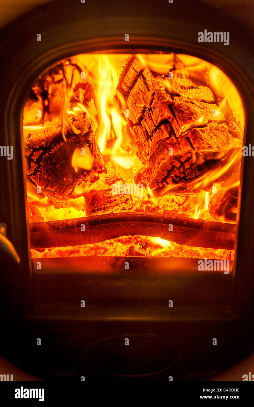 Wood burning stove fire flames logs Stock Photo Alamy