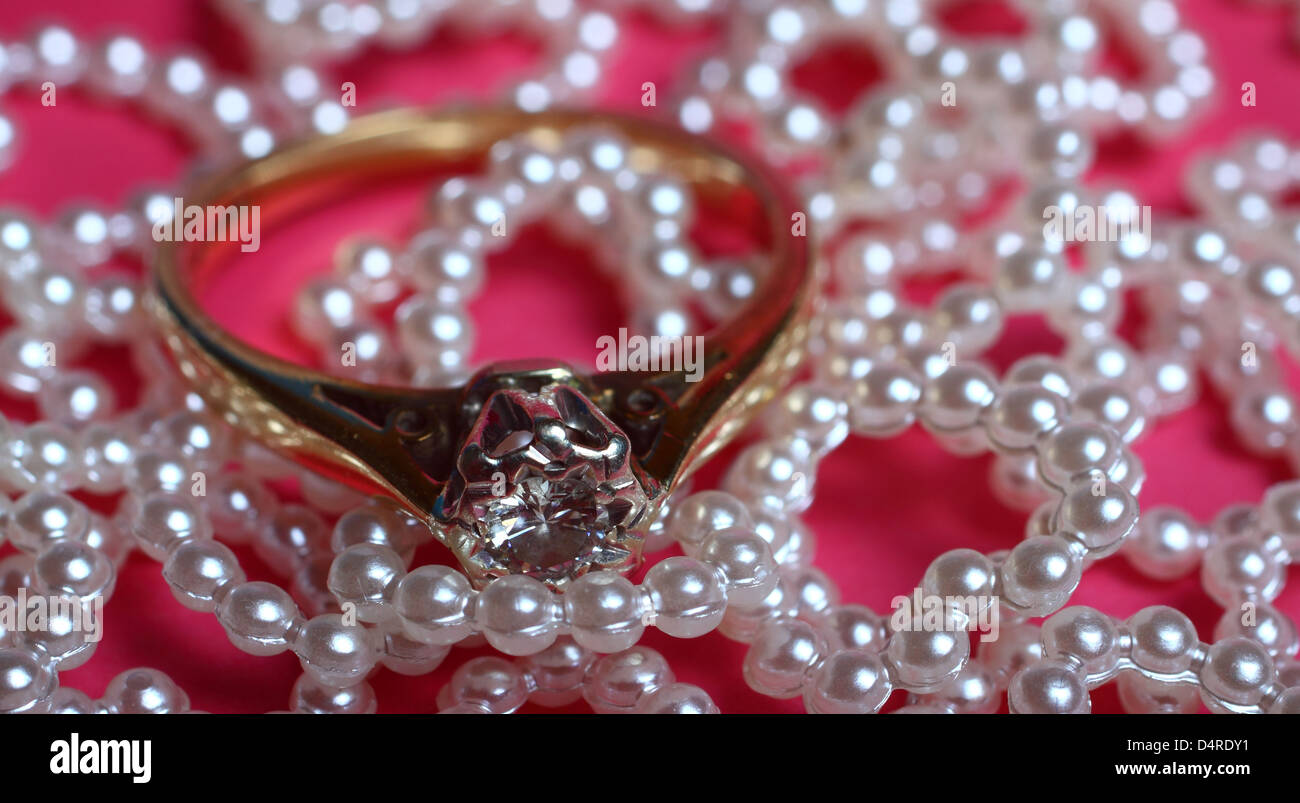 Engagement ring on heart embellishments Stock Photo