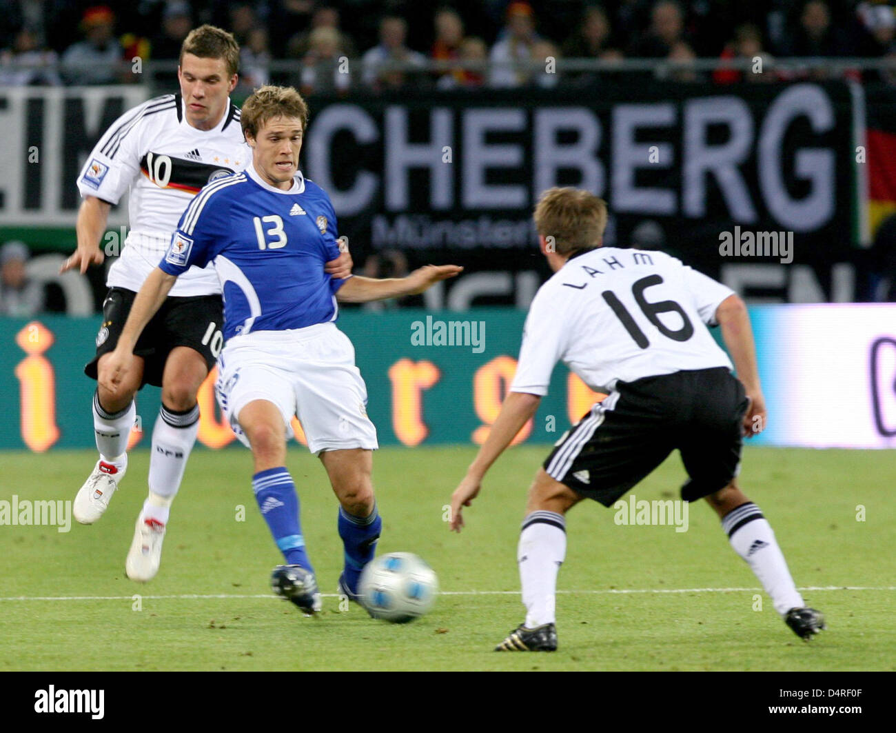 Germany?s Philipp Lahm (R) and Lukas Podolski (L) fight for the ball ...