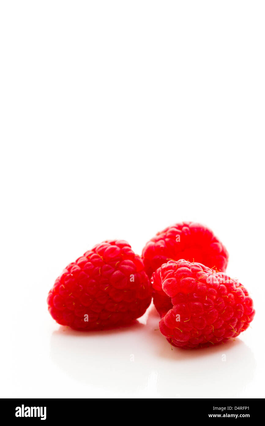 Heap of organic raspberries on white background Stock Photo - Alamy