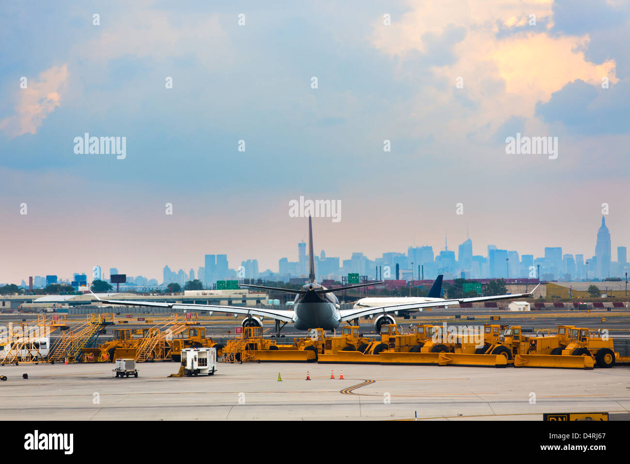 Airports runway and ground services waiting to service. With an airplane in-front of city. Stock Photo