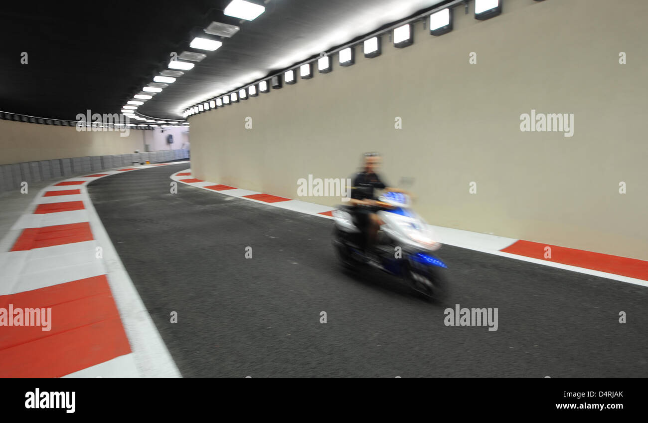 A mechanic on a motorbike drives through the tunnel at the end of the pit line at the newly built Yas Marina Circuit race track in Abu Dhabi, United Arab Emirates, 28 October 2009. The Formula One Grand Prix of Abu Dhabi will take place for the first time on 01 November 2009. Photo: Peter Steffen Stock Photo