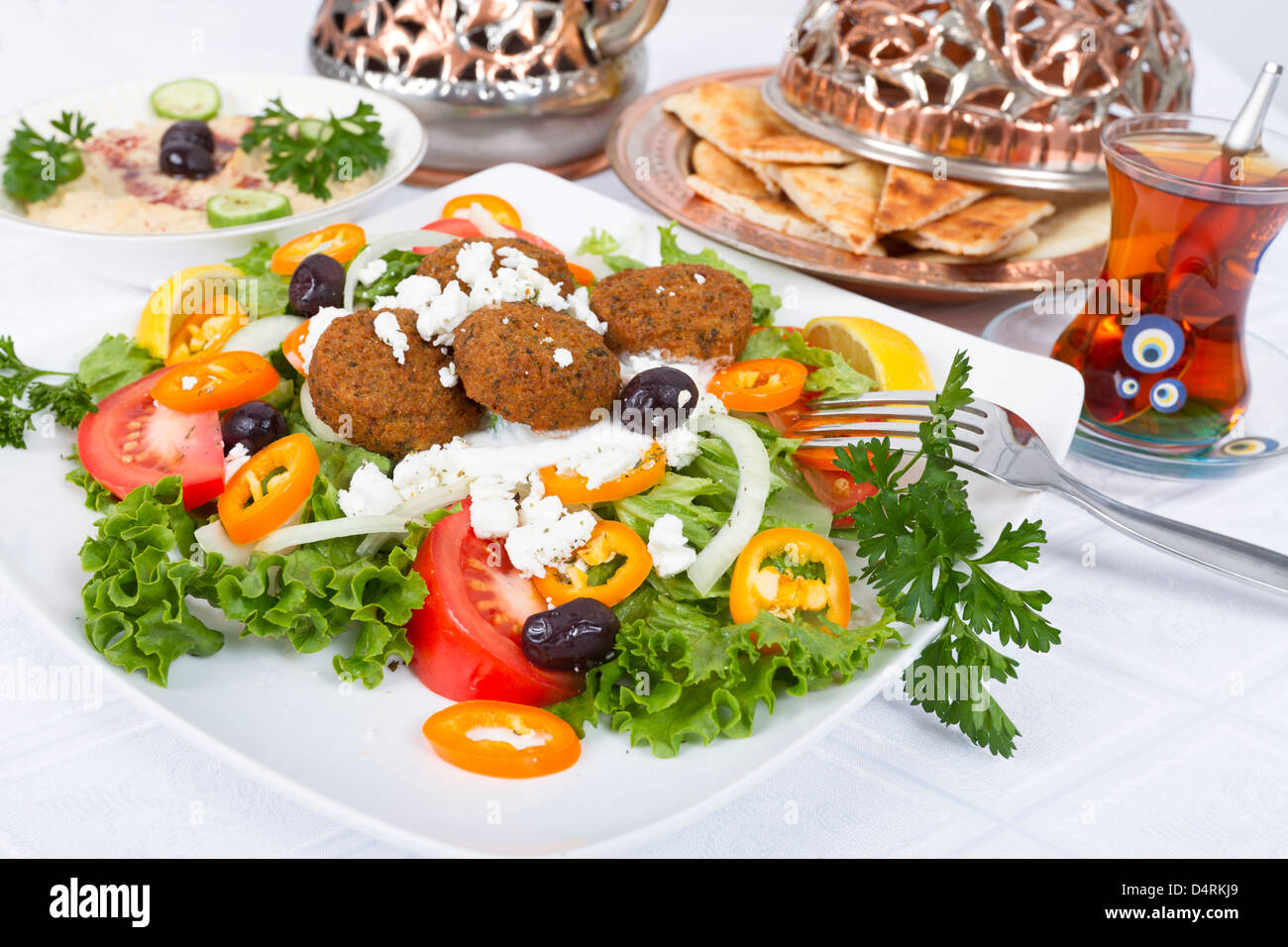 Falafel Salad with Pita Bread and Hummus plate, complimented with tea