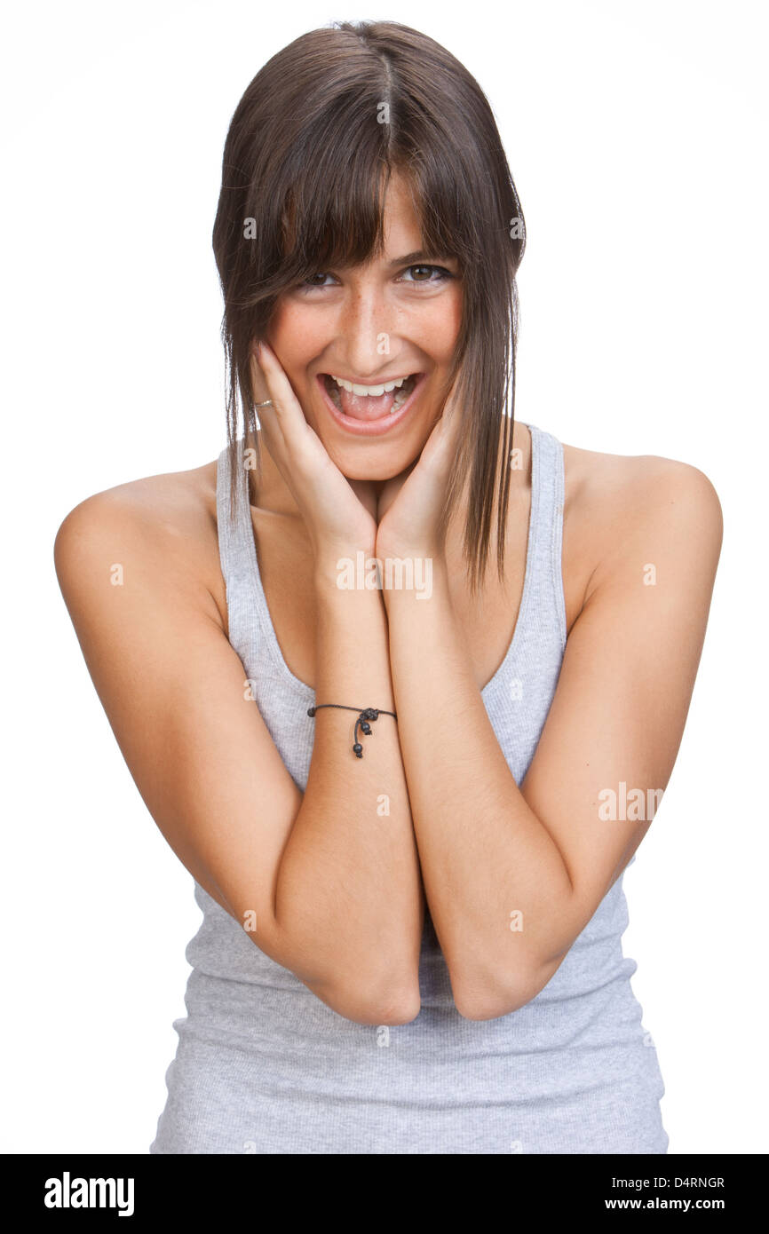 Cutout laughing young woman with long brown hair looking surprised, both hands at her face Stock Photo