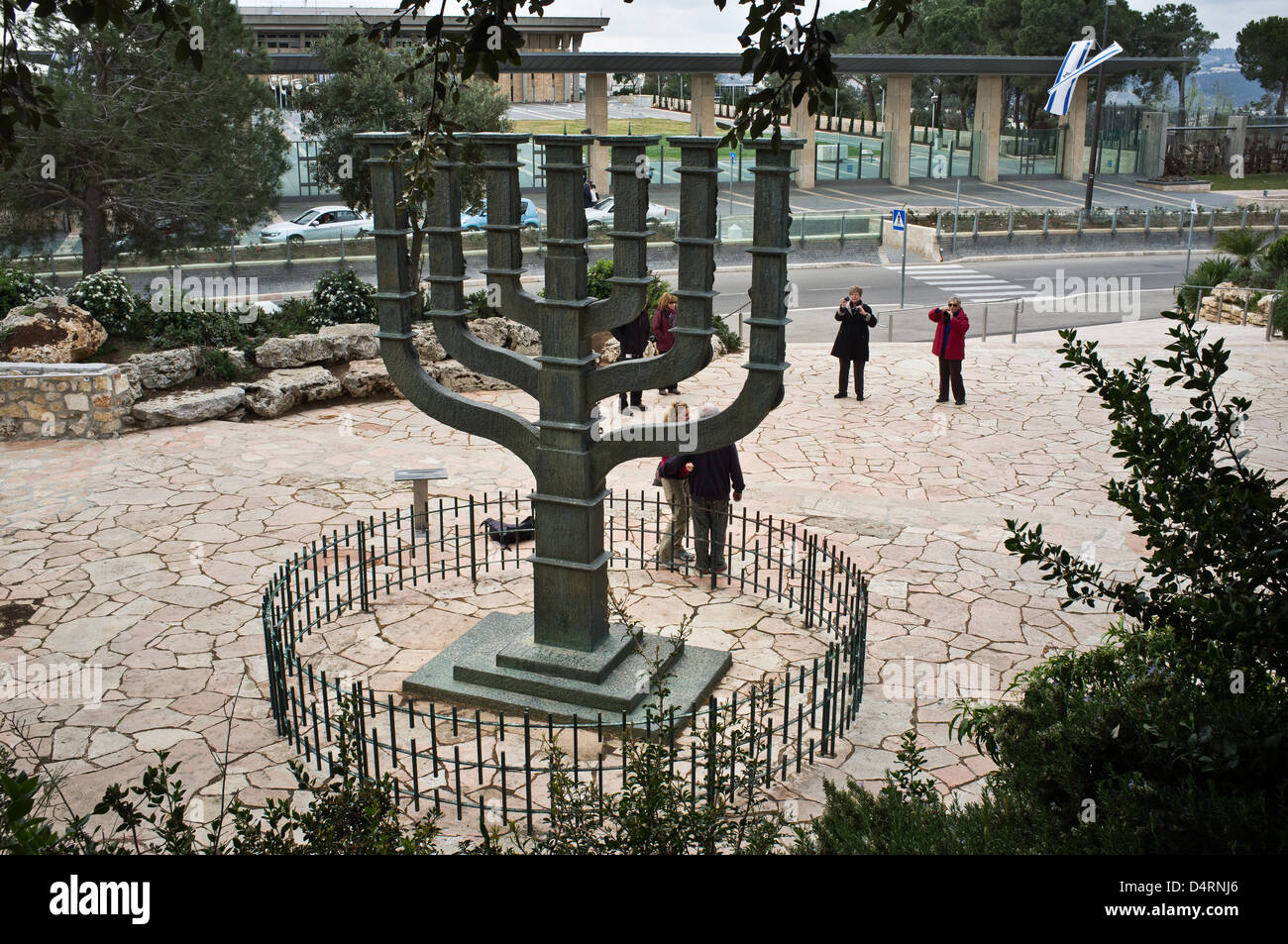 Tourists pose for photographs at a menorah on display opposite the