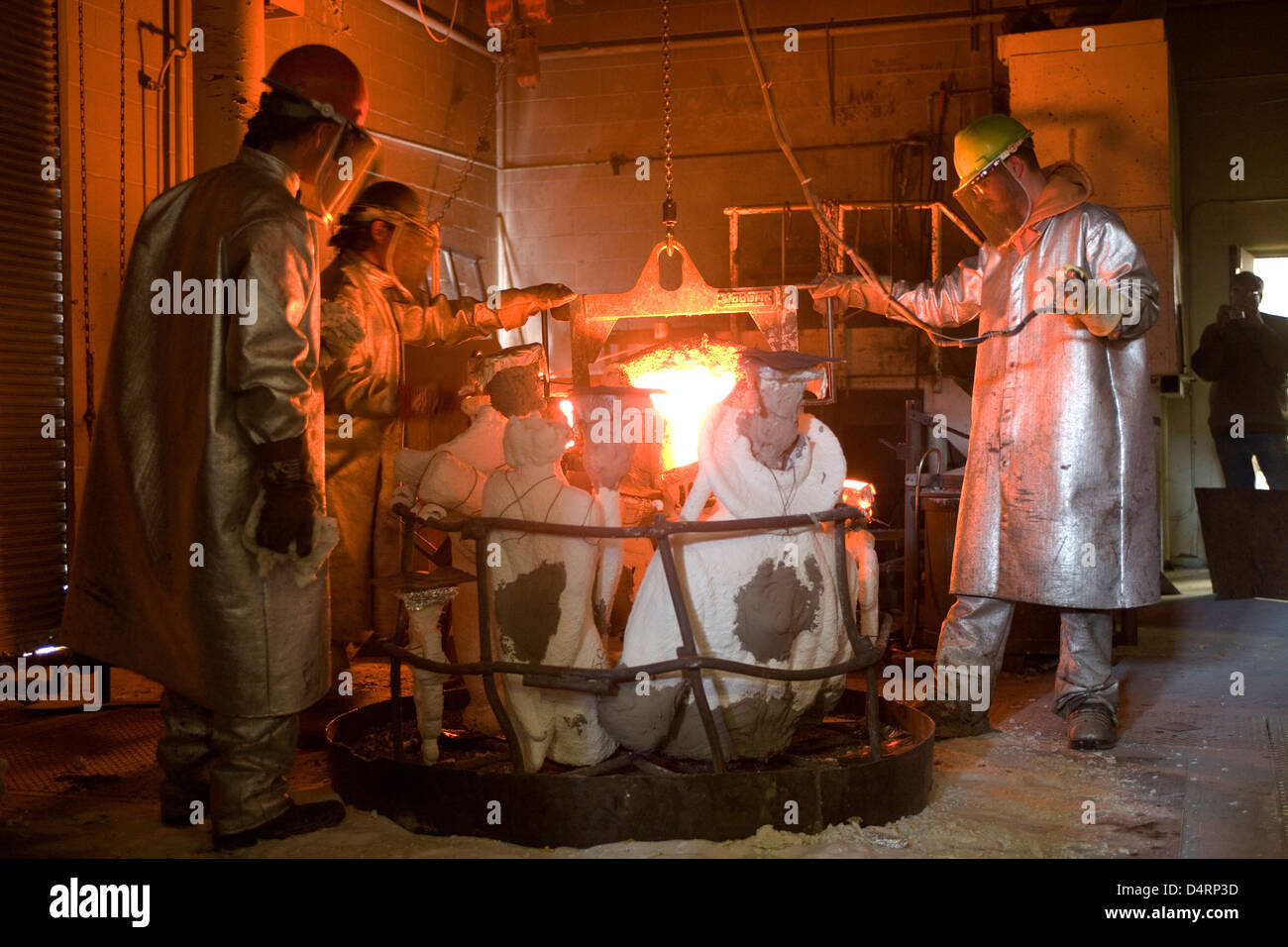 Tesuque: Shidoni Foundry, Galleries & Sculpture Garden / pouring molten bronze into molds Stock Photo