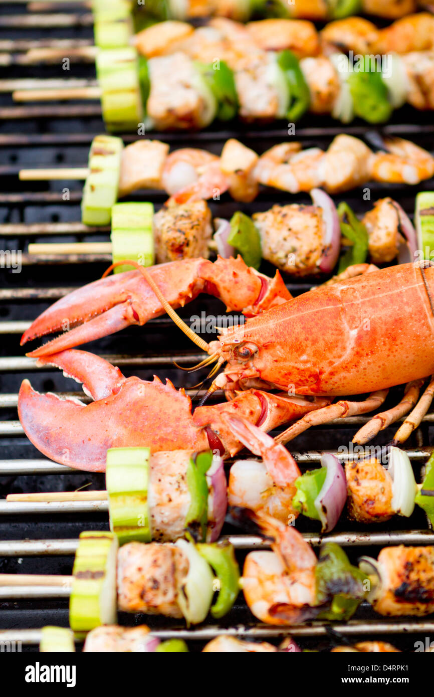 Lobster and fish skewers are on the barbecue Stock Photo Alamy