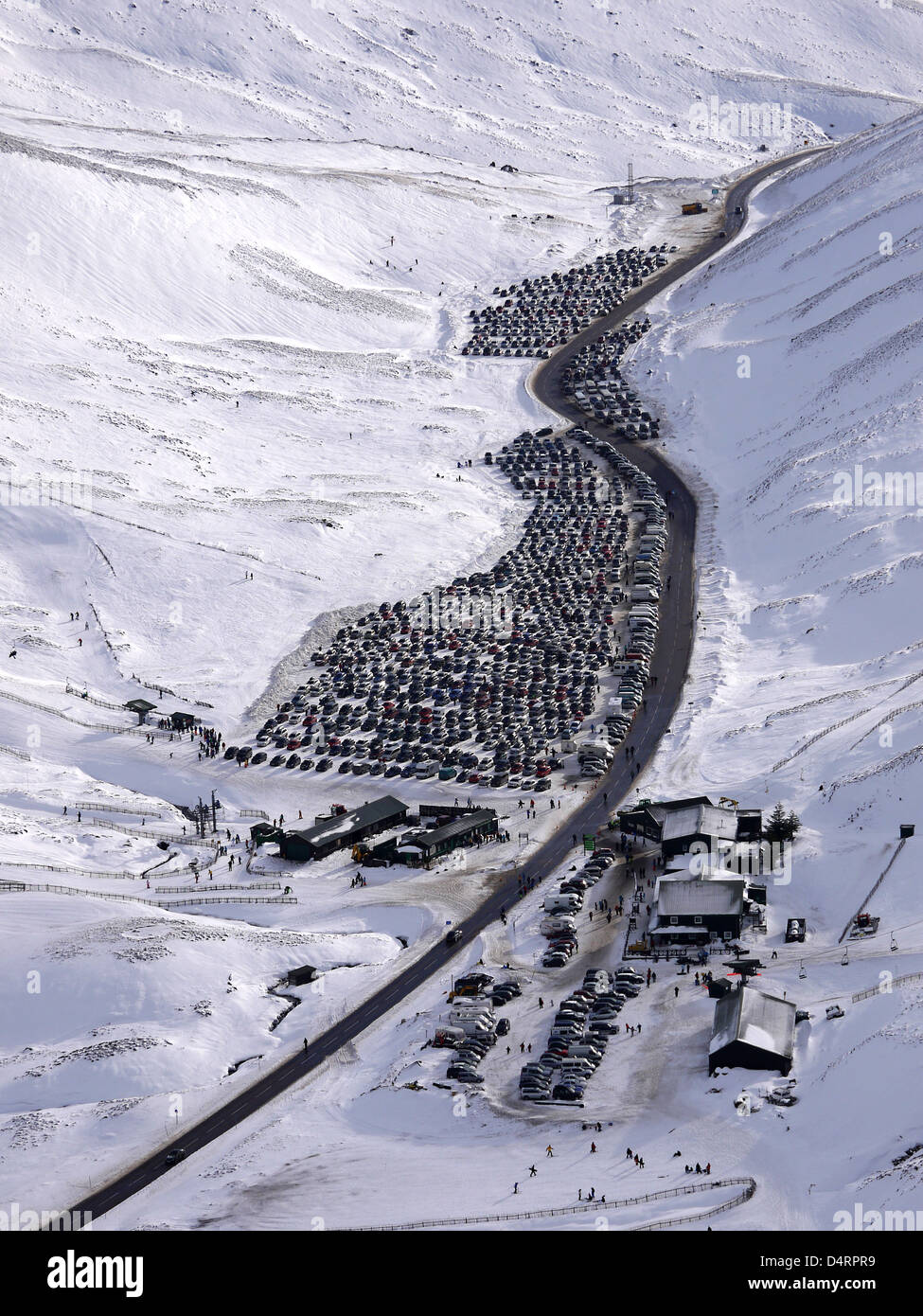 View of the main arterial road from Perth to Braemar in winter with the car park of Glenshee ski resort very busy Stock Photo