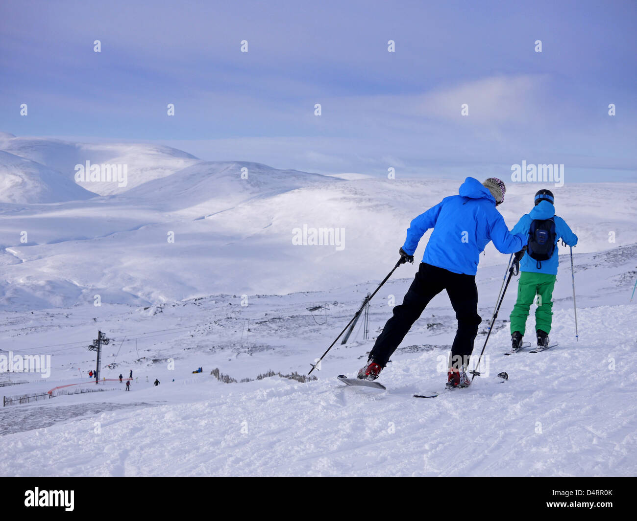 Skiers at Glenshee ski resort in Scotland traverse across the hill Stock Photo
