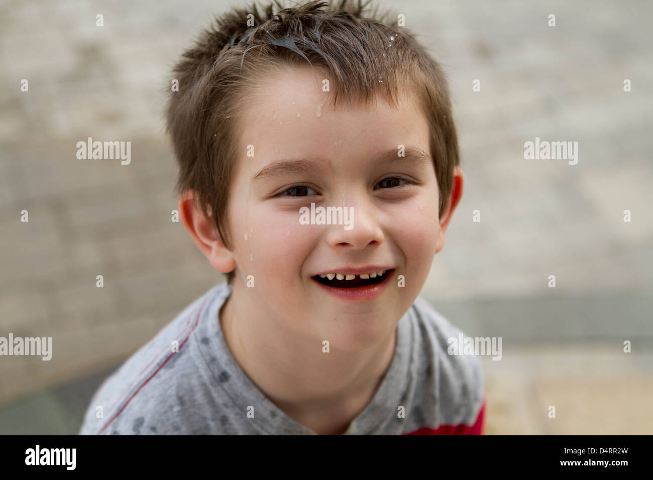 Six years old kid looking at camera with a mischievous don't care face