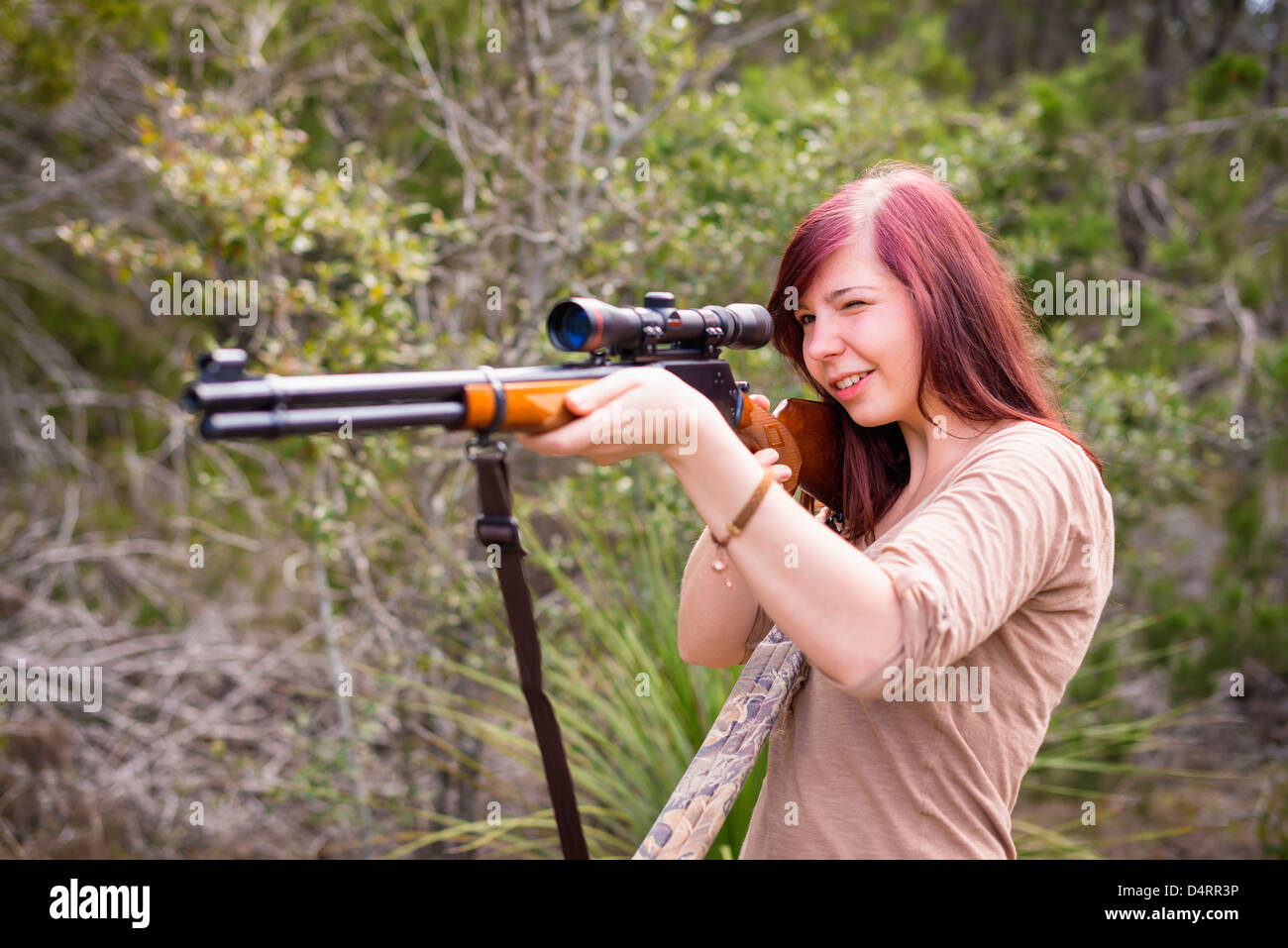 Young woman shooting a hunting rifle firearm, Female 19 Caucasian, Texas, USA Stock Photo