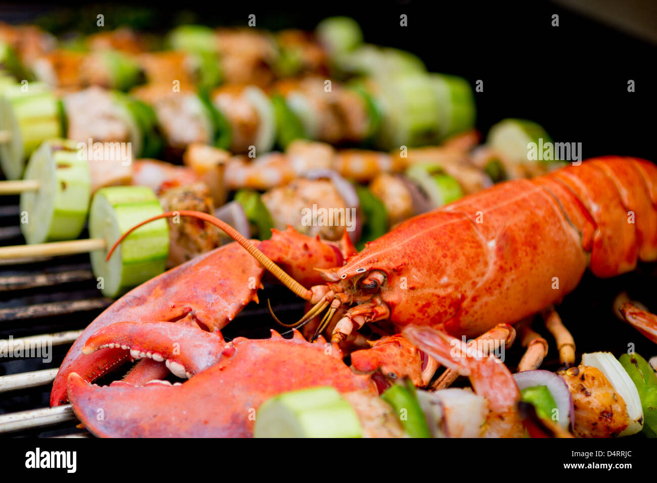 Lobster and fish skewers are on the barbecue Stock Photo Alamy
