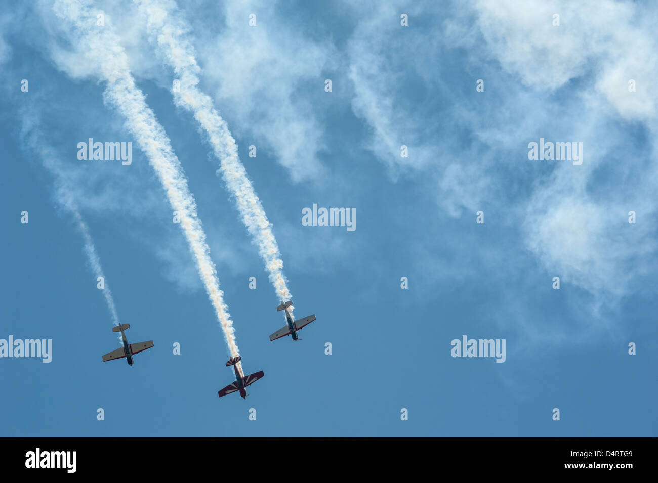 Three planes diving out of the smoke against a clear blue sky at the 2013 Thunder in the Valley Air Show in Columbus, Georgia. Stock Photo