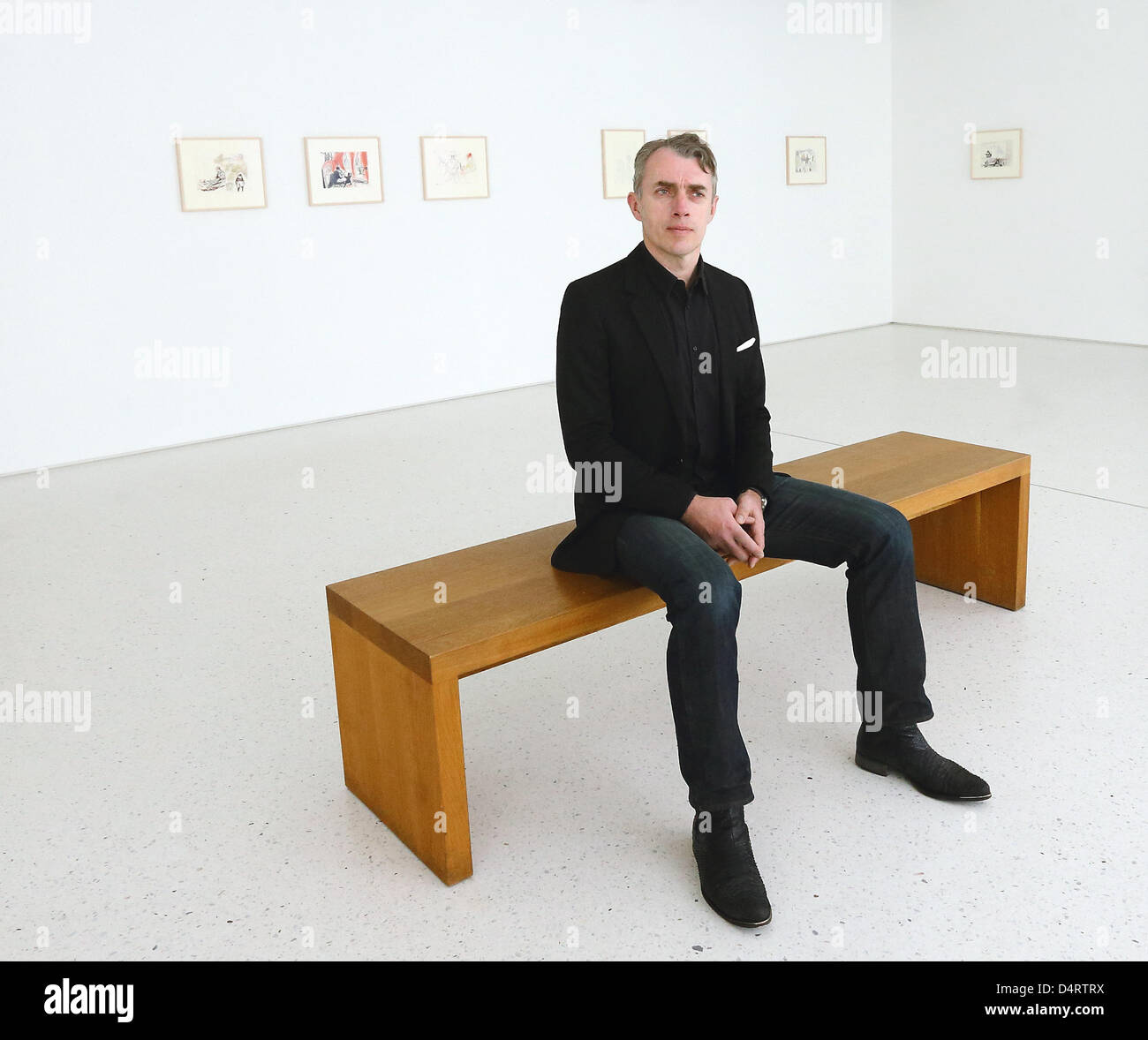 Neo Rauch sits in the exhibition 'Neo Rauch - The Graphic Work - Part 2' in the Grafikstiftung in Aschersleben, Germany, 15 March 2013. The exhibition opens on 17 March 2013. Rauch spent his childhood and youth in the city. Photo: Jens Wolf Stock Photo
