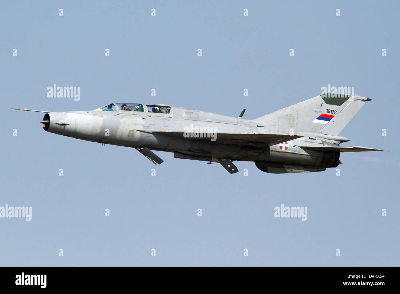 A Serbian Air Force MiG-21UM jet fighter with air brakes, in flight over Serbia. Stock Photo