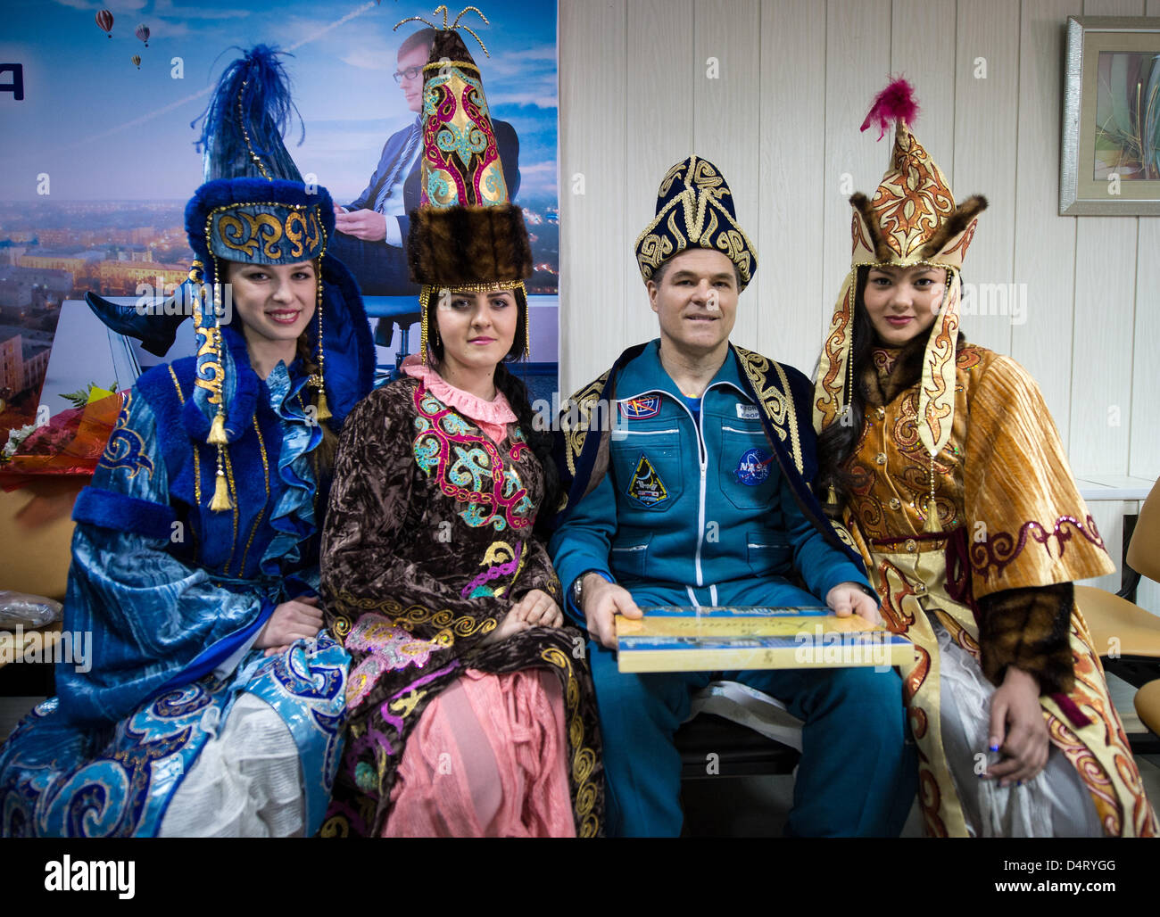 Expedition 34 Commander Kevin Ford of NASA poses for a photograph with women in ceremonial Kazakh dress at the Kustanay Airport March 16, 2013 in Arkalyk, Kazakhstan. Novitskiy, Tarelkin, and Ford returned from 142 days onboard the International Space Station where they served as members of the Expedition 33 and 34 crews. Stock Photo