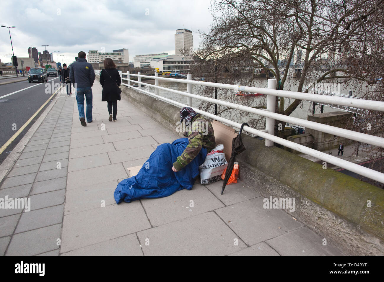 Homeless man on Waterloo Bridge, central London, England, UK Stock Photo