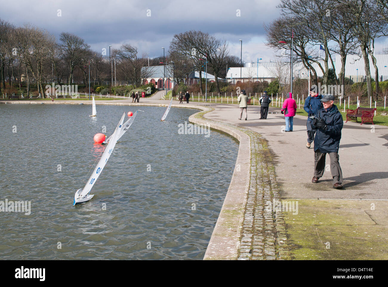Enthusiasts sailing radio controlled model yachts in South Marine Park South Shields north east England UK Stock Photo