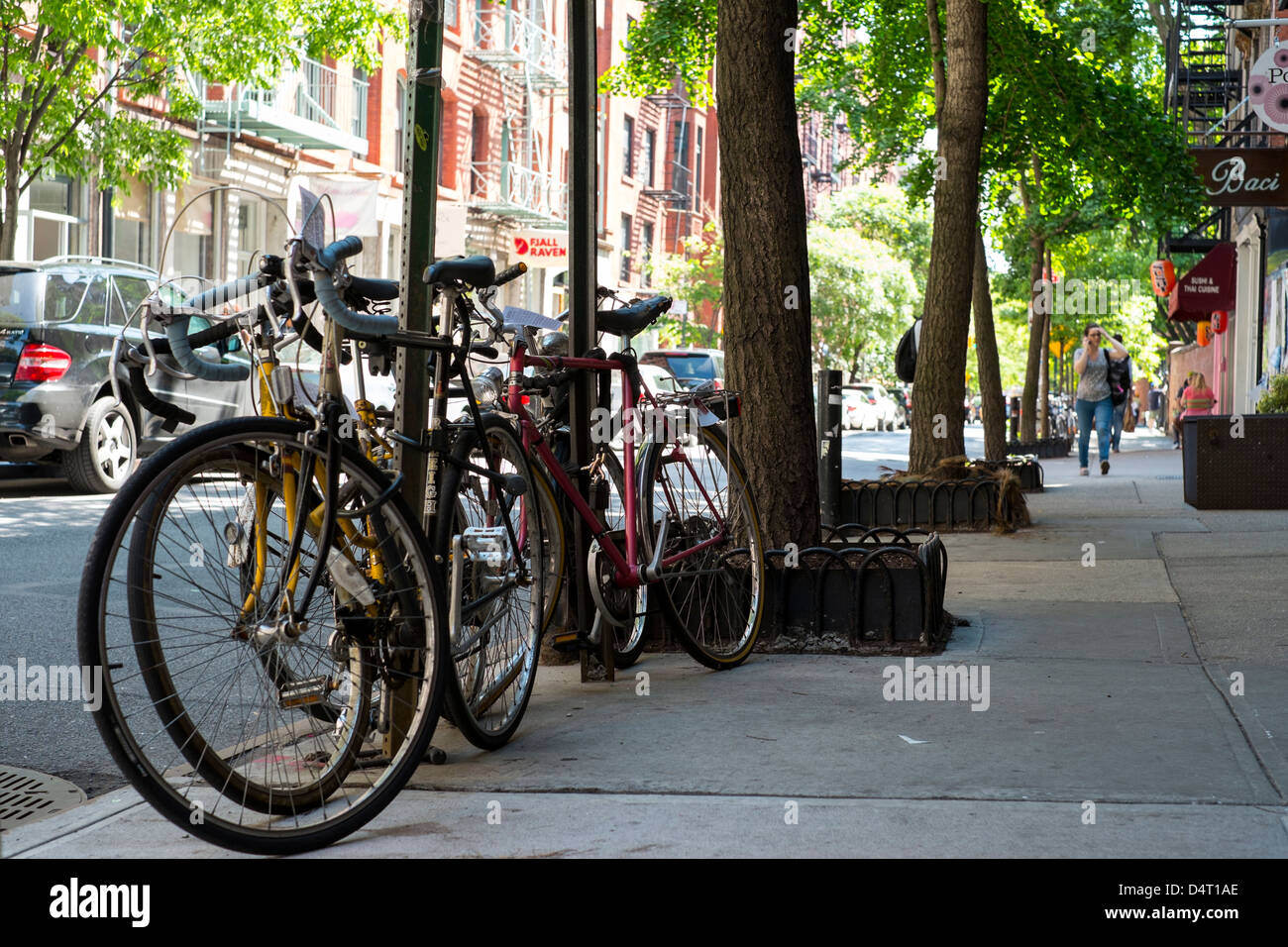 Commuter bicycles locked to a lamp post. New York Stock Photo