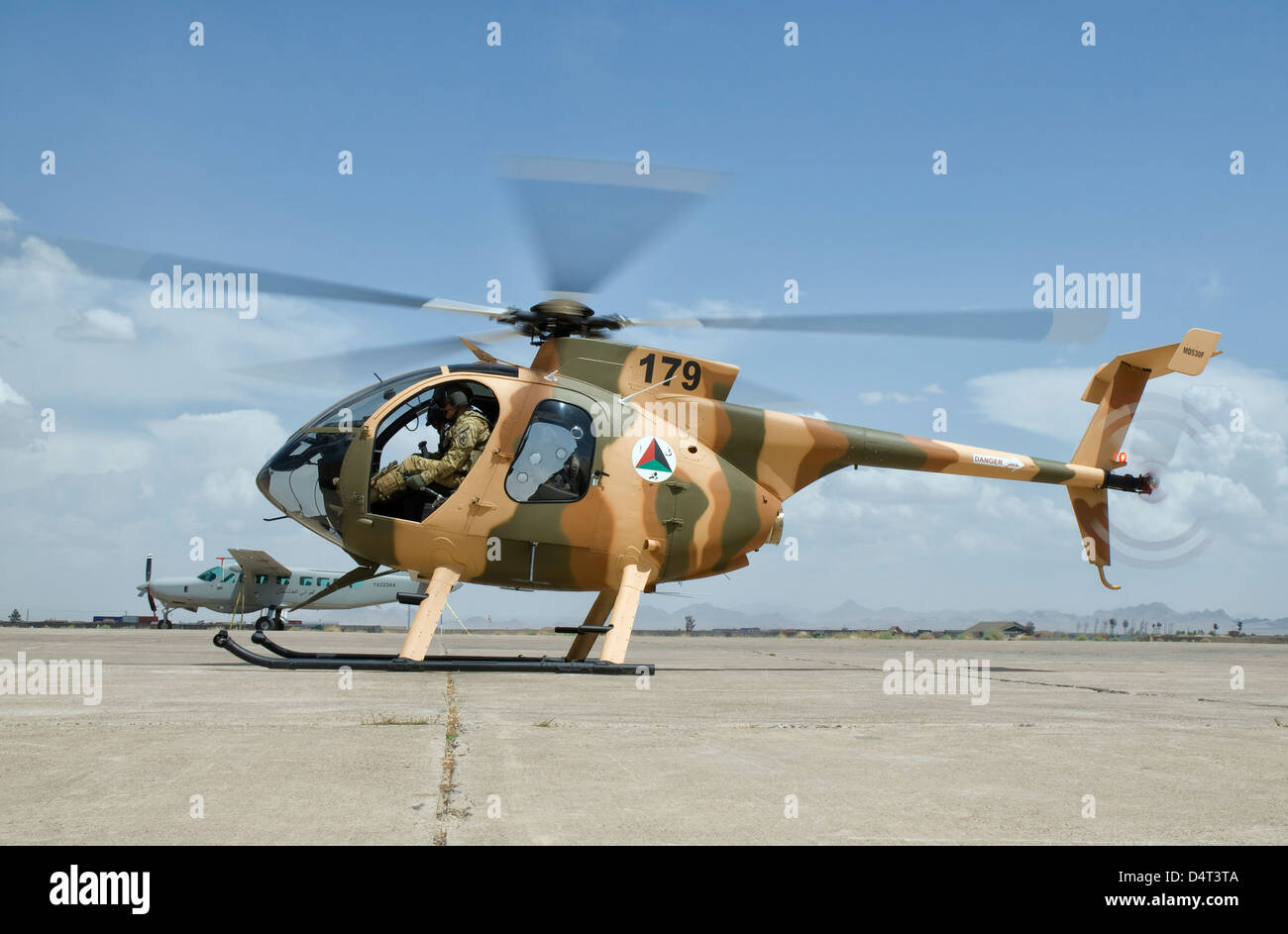An Afghan Air Force MD-530F helicopter ready to take off on the ramp at Shindand Air Base, Afghanistan. Stock Photo