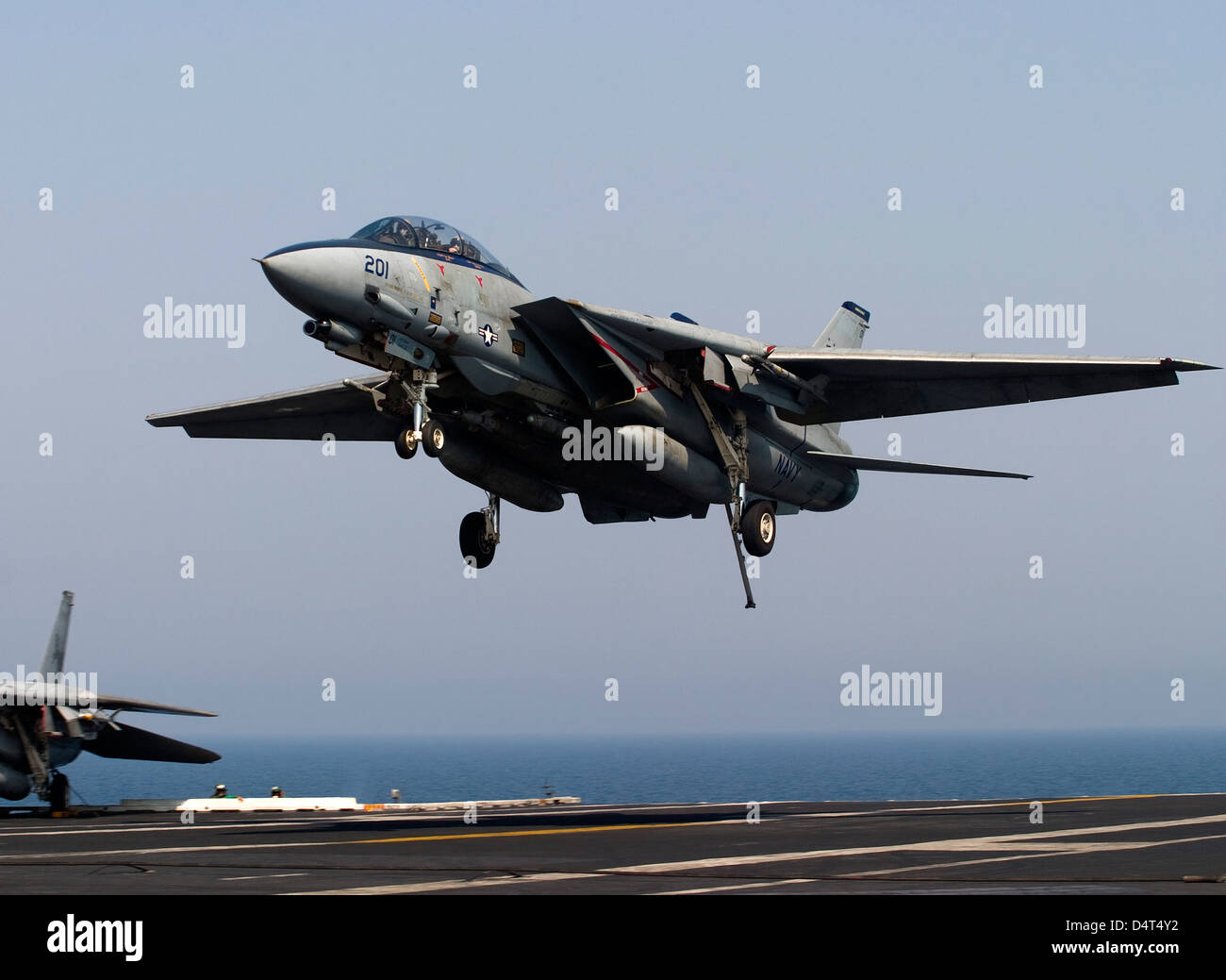 An F-14D Tomcat comes in for an arrested landing on the flight deck of USS Theodore Roosevelt. Stock Photo
