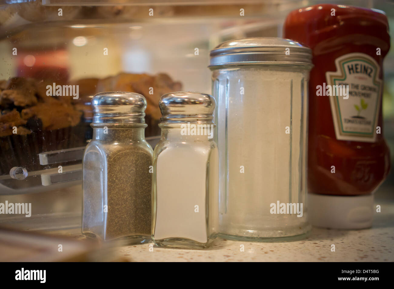 Salt, pepper, sugar and a bottle of Heinz Tomato Ketchup on a