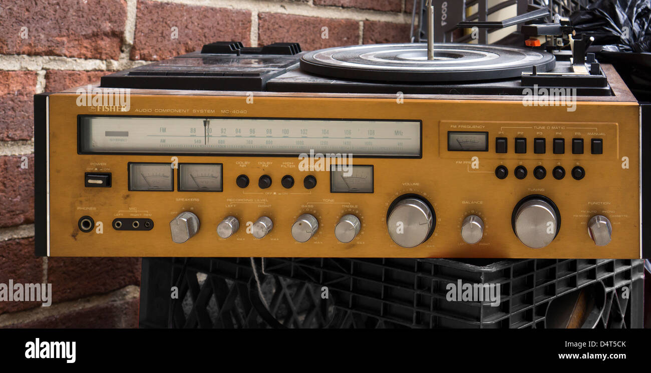 A Fisher brand discarded stereo receiver with turntable and cassette