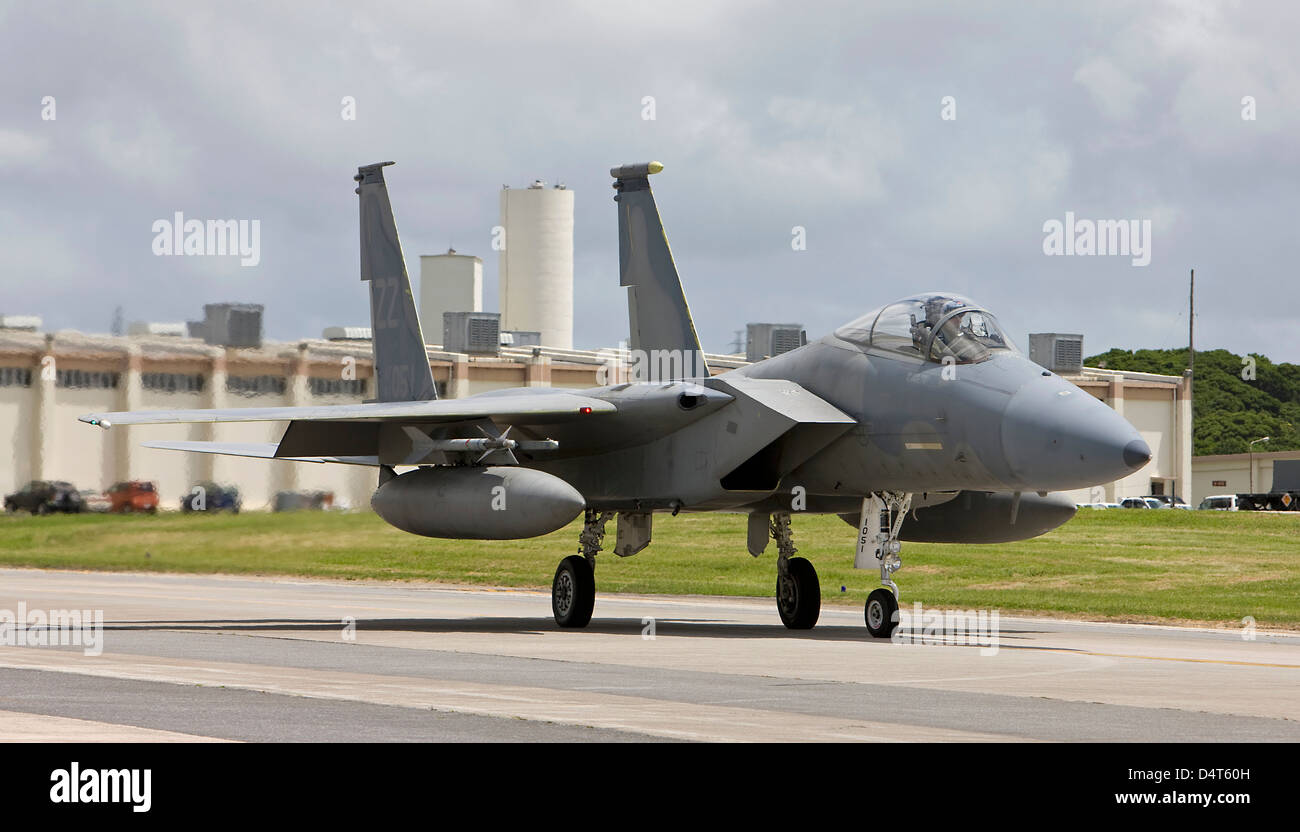 An F-15 from the 18th Wing at Kadena Air Base, Okinawa taxi's to the end of runway to complete its pre-flight checks. Stock Photo