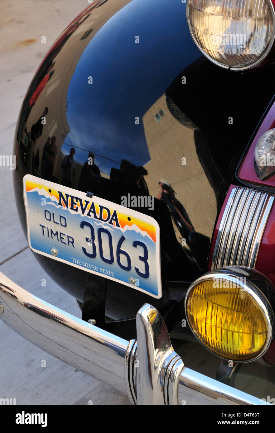 An image of the photographer is reflected in the fender of a 1937 Oldsmobile with Nevada 'Old Timer' license plate Stock Photo