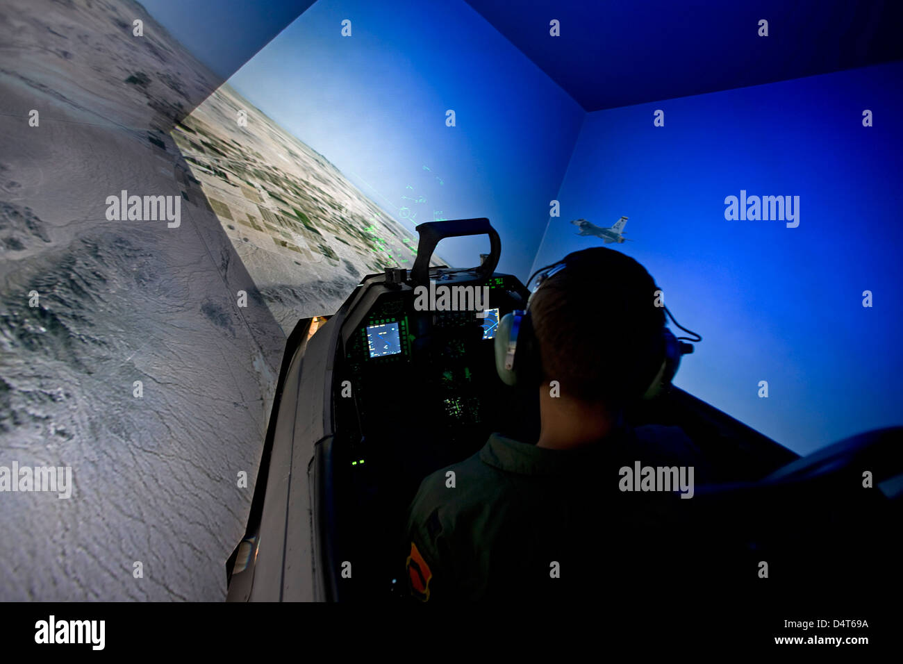 A pilot from the 56th Fighter Wing in Luke Air Force Base, Arizona, flies the F-16 simulator. Stock Photo