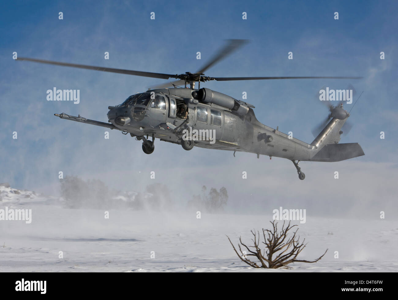 An HH-60G Pave Hawk fly's low over a landing zone in New Mexico. Stock Photo