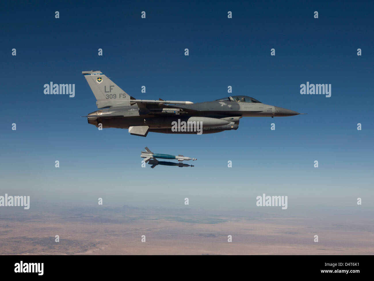 An F-16 Fighting Falcon releases two GBU-12 laser guided bombs. Stock Photo