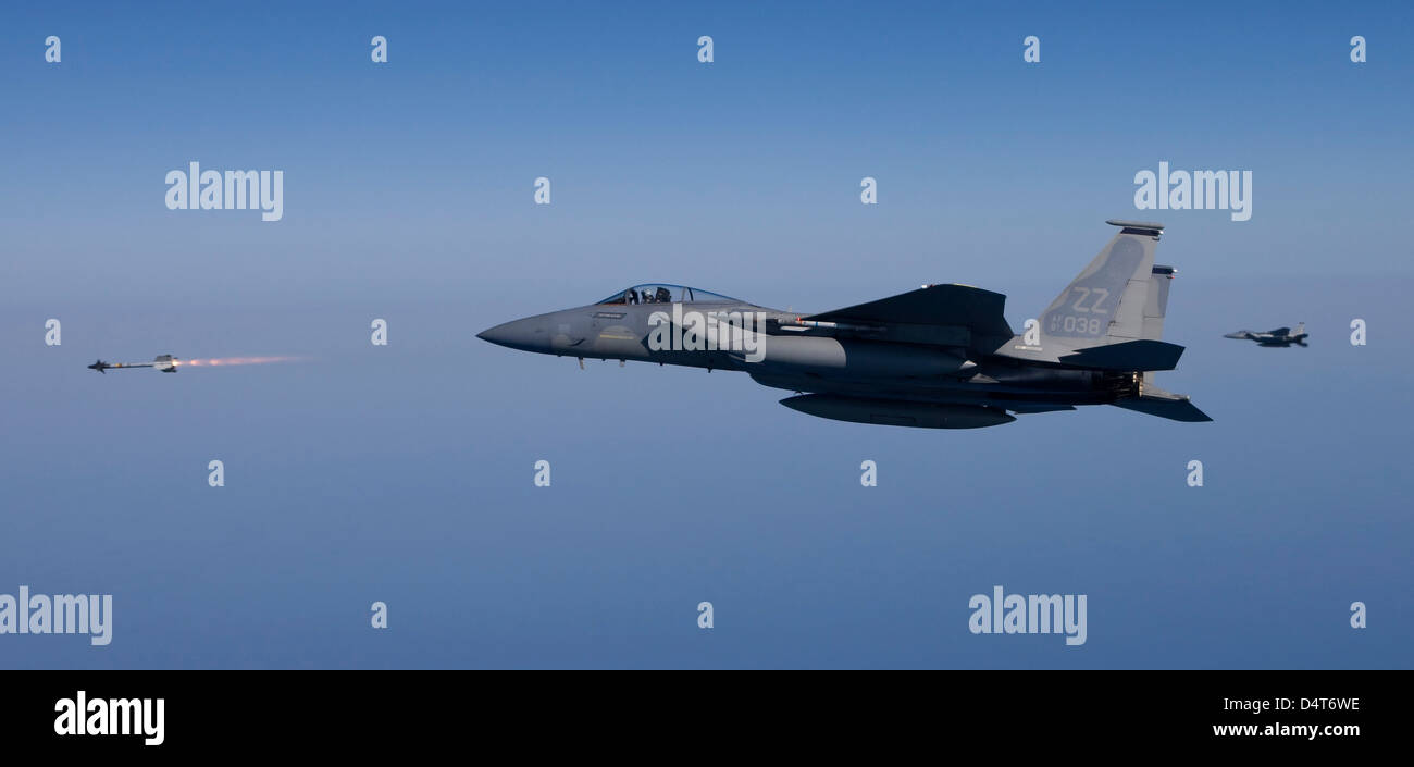 An F-15 Eagle fires an AIM-9 missile. Stock Photo