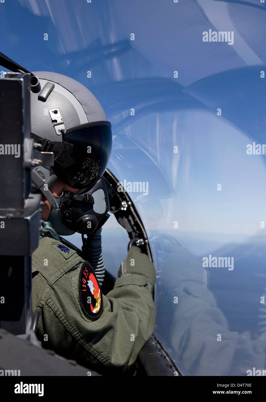 A F-15 pilot from the 114th Fighter Squadron looks over at his wingman during a training mission over Central Oregon. Stock Photo
