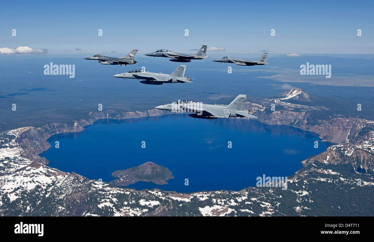 A five ship aircraft formation flies over Crater Lake, Oregon Stock