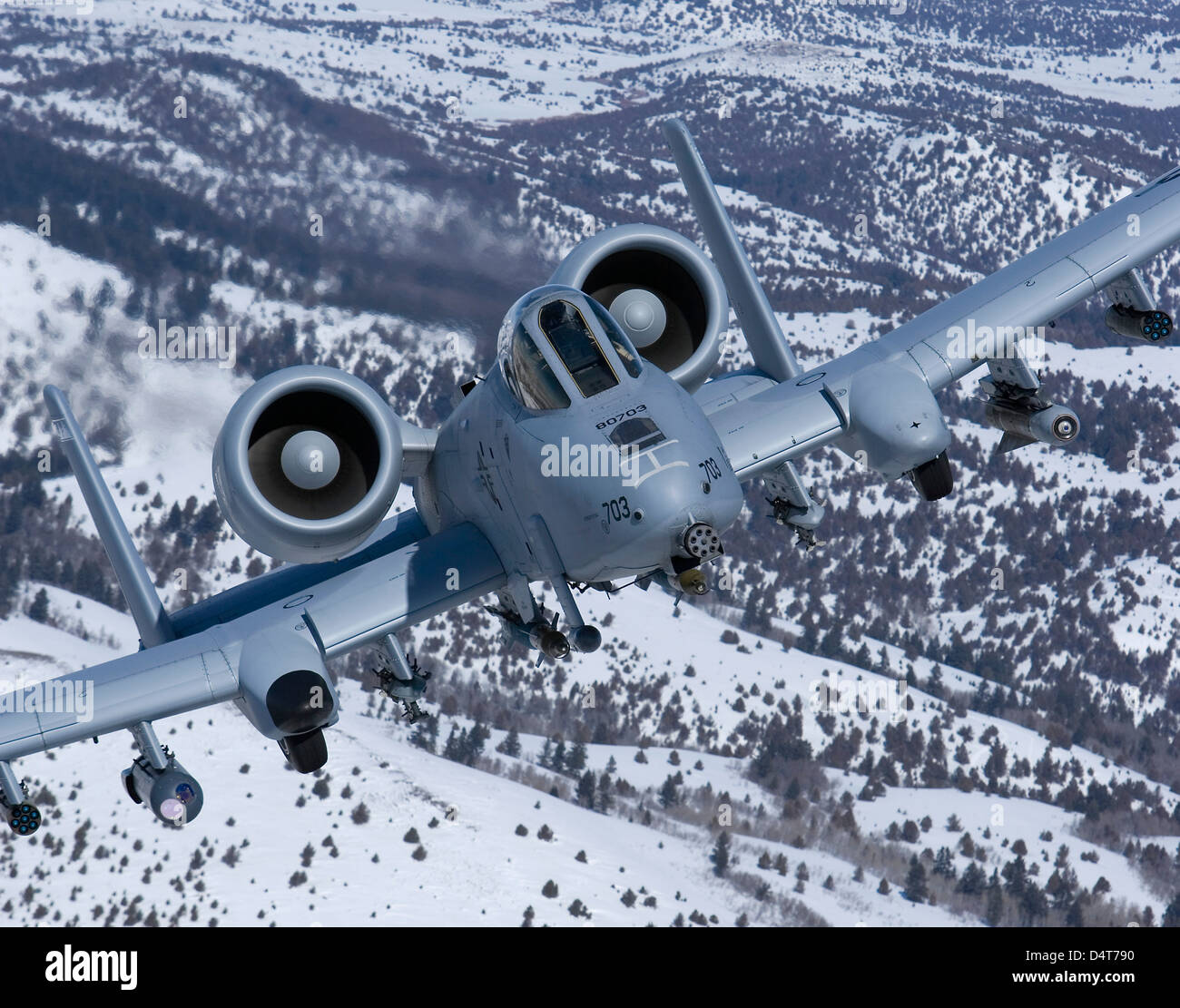 An A-10C Thunderbolt flies over the snowy Idaho countryside. Stock Photo